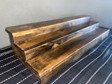 Reclaimed wood triple tier alcohol display shelf in dark walnut finish